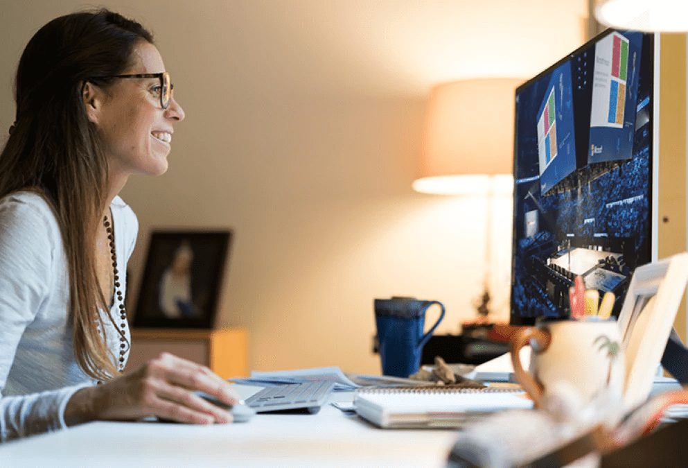 photograph-of-a-person-watching-a-large-event-on-their-desktop-monitor-in-their-home-office-interstellar-business-solutions-limited-ibsl