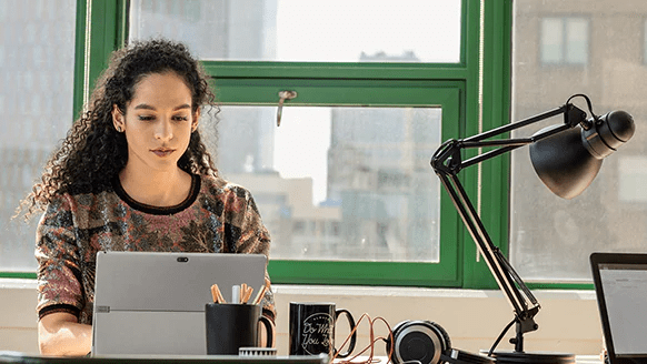 photograph-of-a-person-seated-in-a-shared-office-space-working-on-a-laptop-interstellar-business-solutions-limited-ibsl