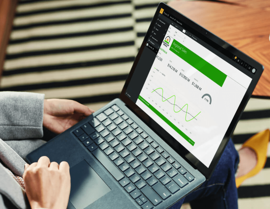 power-bi-a-person-sitting-with-a-laptop-looking-at-a-sales-performance-report-interstellar-business-solutions-limited-ibsl